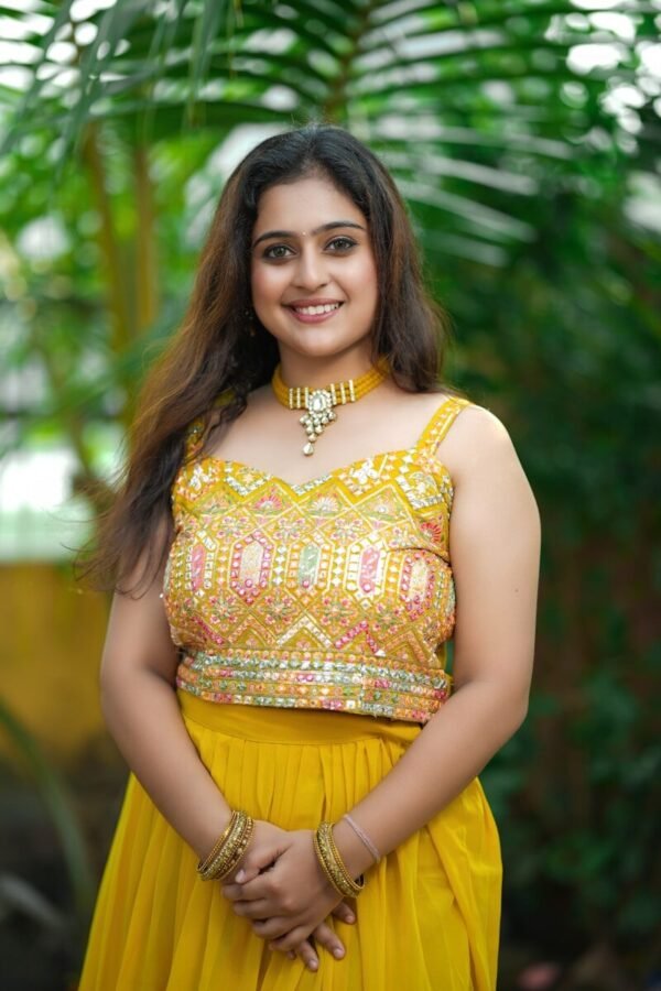 a woman in a yellow dress posing for a picture